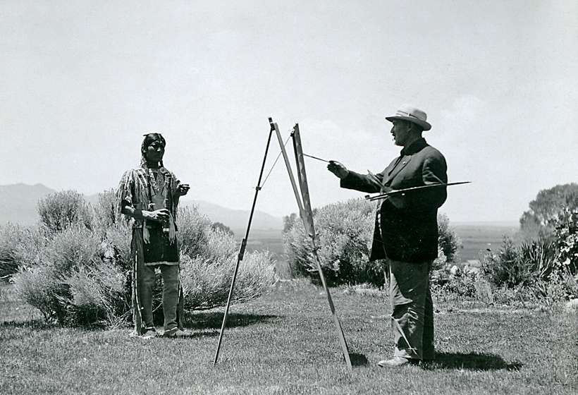 Couse painting a model in his garden, circa 1915.