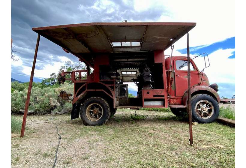 The mobile machine shop with awning doors open showing the machinery on board