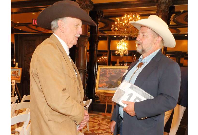 Patron Dean Snyder of Denver, left, talks art with Michael Grauer, McCasland Curator of Cowboy Culture at the National Cowboy & Western Heritage Museum.