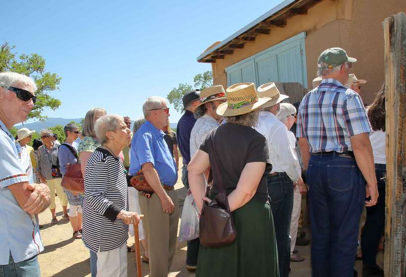 The crowd files in for the first public viewing of the restored studio and exhibition.